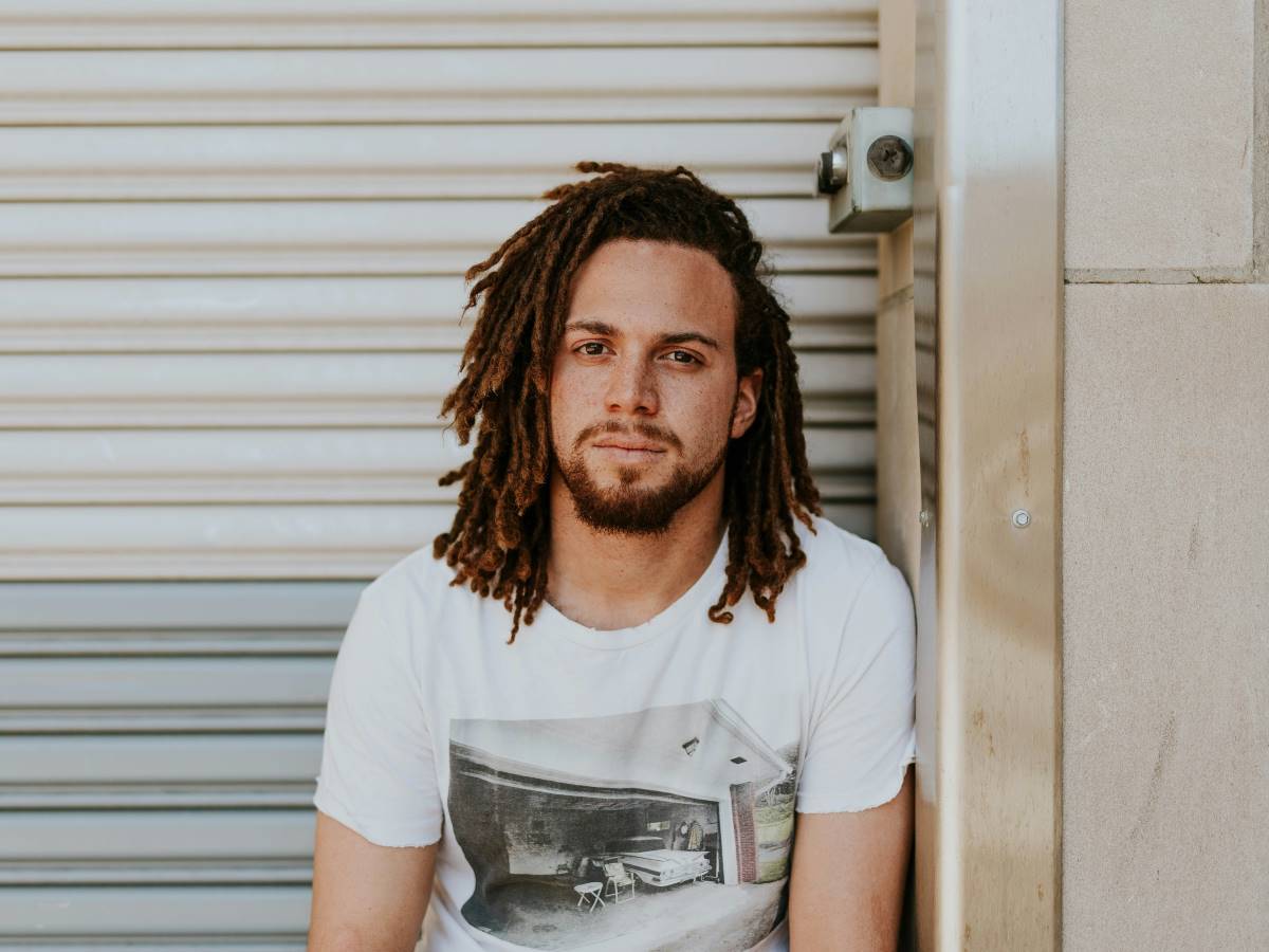 a man with dreadlocks looking at the camera