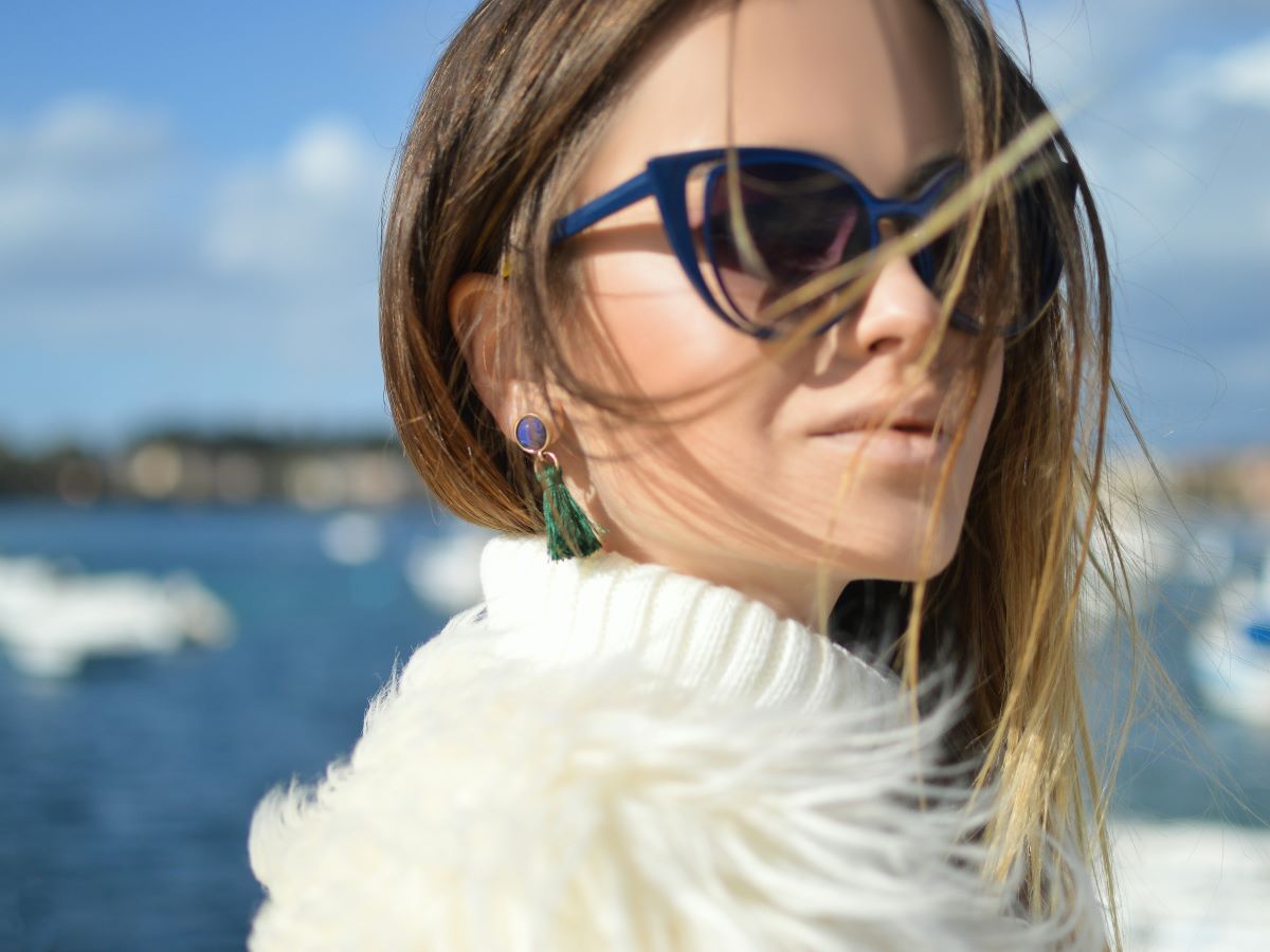 a woman with shades in a jacket