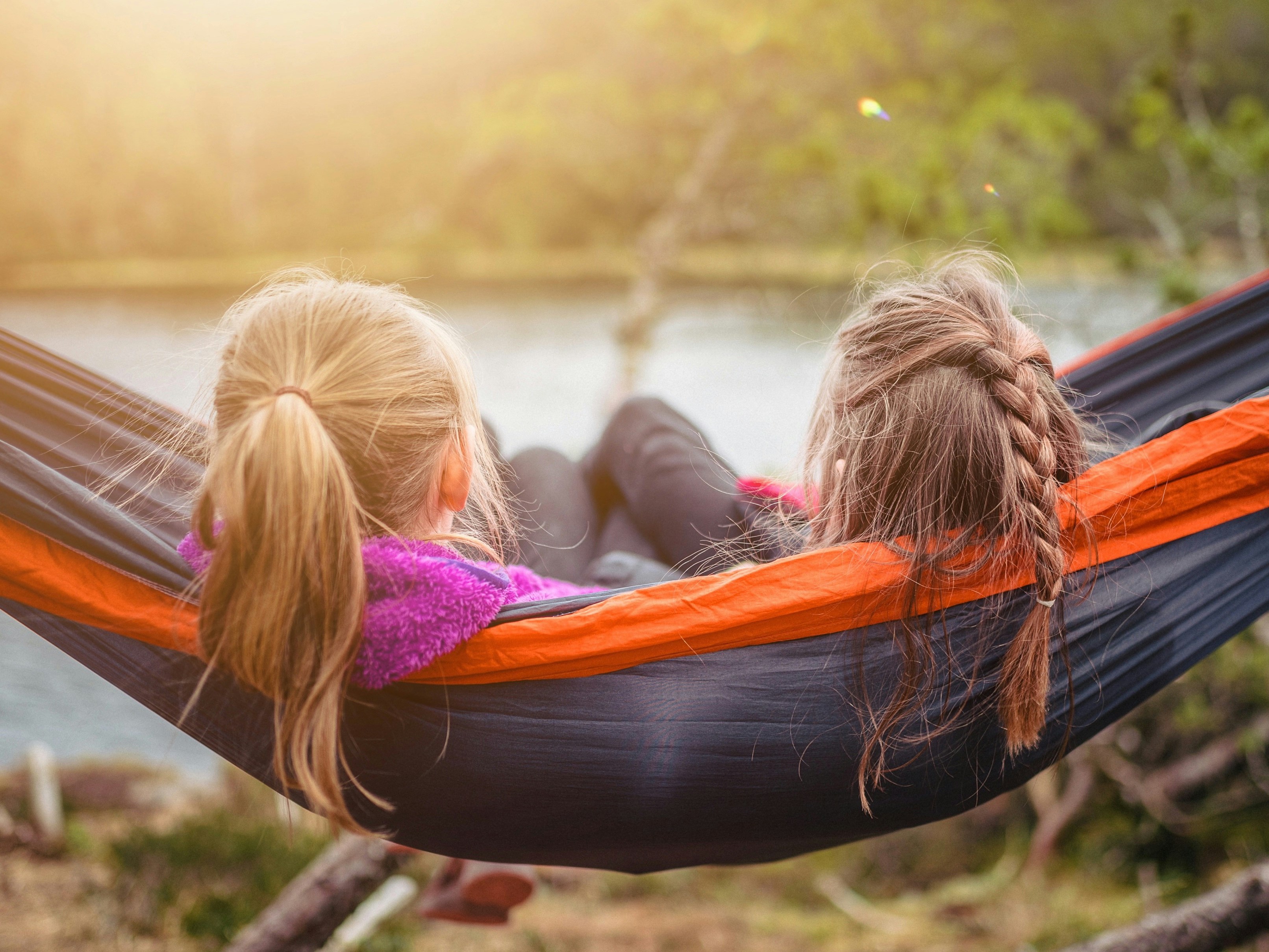 two female friends hanging in a hammock