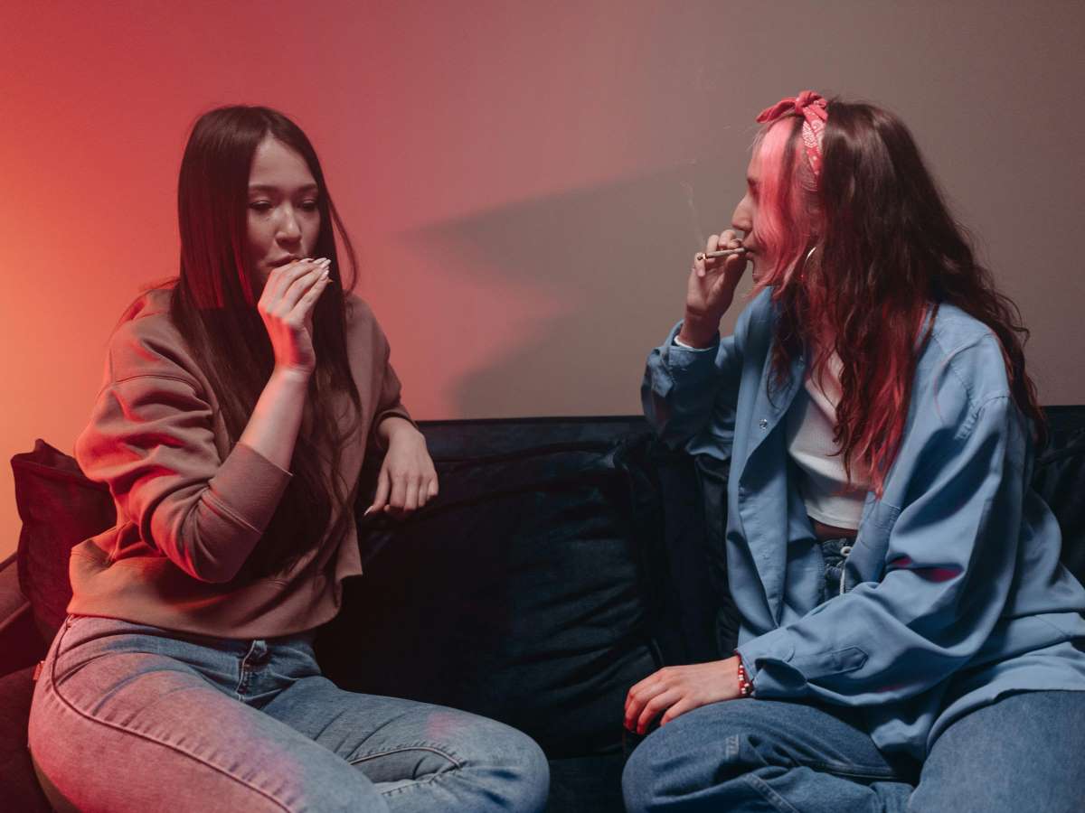 two women smoking a joint